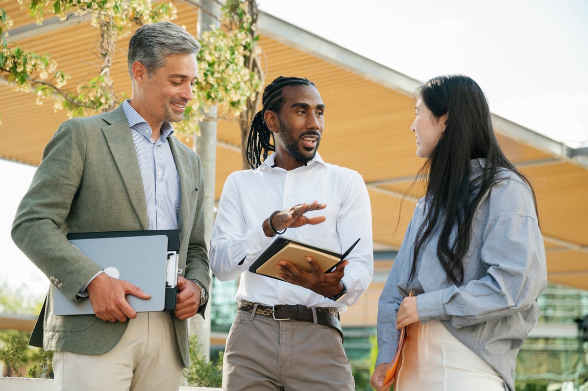 A group of professionals talking and standing outside