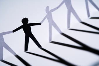 paper cutouts joining hands