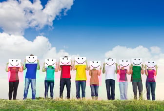 people standing with smiley face drawings over their faces