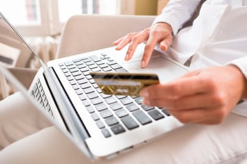person with laptop making an electronic payment for HOA fees