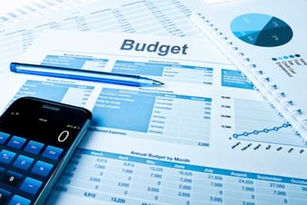 budget sheet, calculator and pen