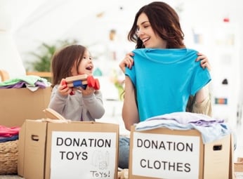 Mother and daughter with donation boxes