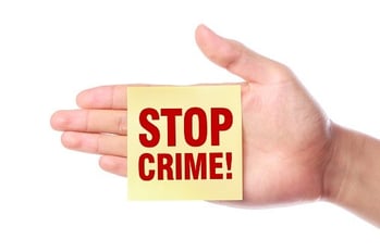 stop crime post-it note stuck to hand