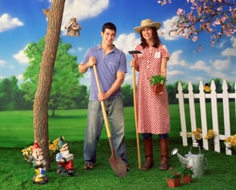 man and woman holding gardening tools