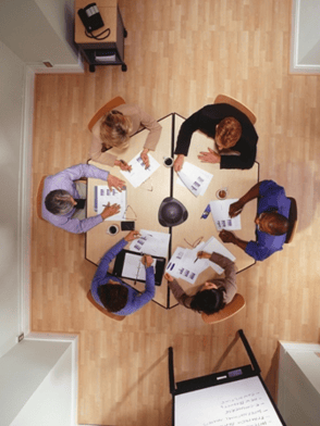 group of people sitting around a meeting table