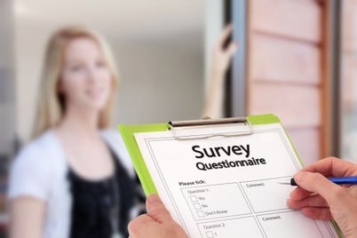 person at door with survey questionnaire