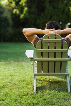 man relaxing in backyard