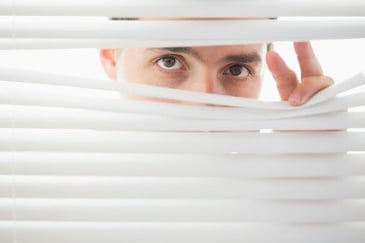suspicious_male_looking_through_blinds