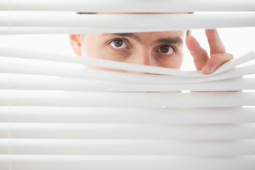 suspicious_male_looking_through_blinds