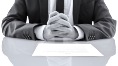 lawyer at desk with hands folded