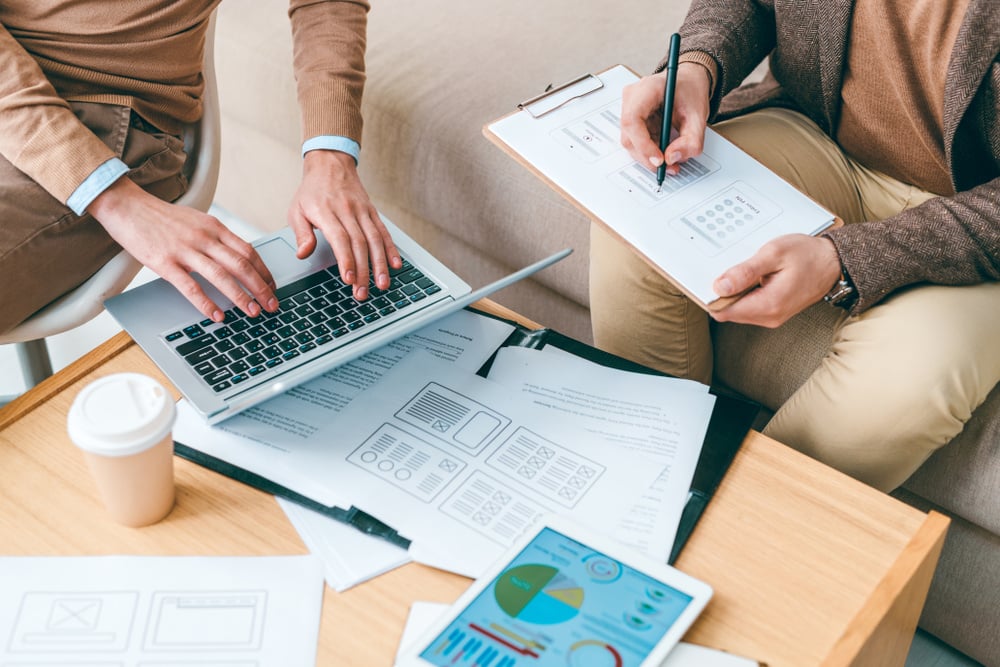 two people preparing paperwork