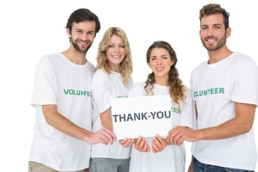 volunteers holding thank you sign