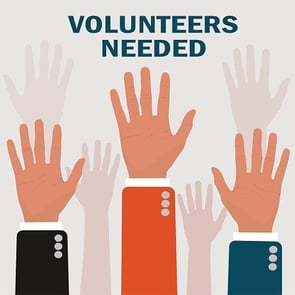 volunteers needed with hands raised